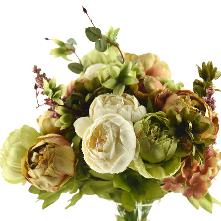 A close-up of a realistic artificial bouquet featuring green and white peonies, with soft greenery and accents of brown leaves for a natural look.