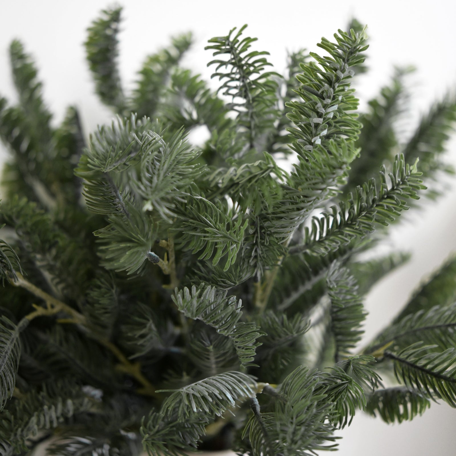 Close-up of realistic green faux pine foliage and branching