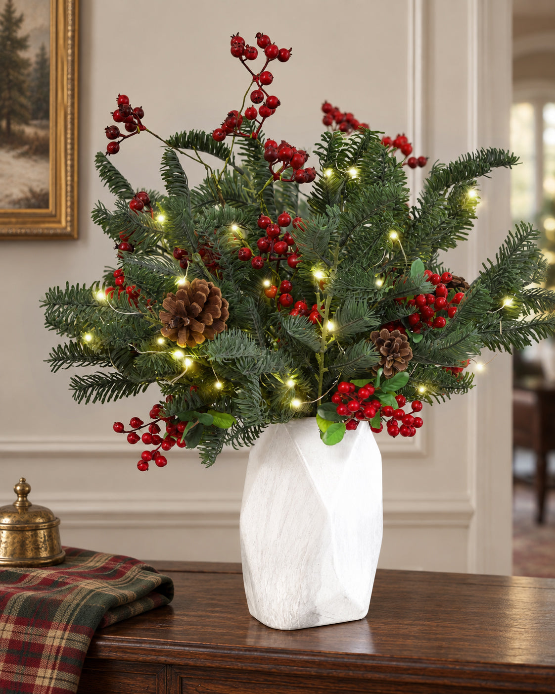 Artificial pine greenery styled with lights on a Christmas console