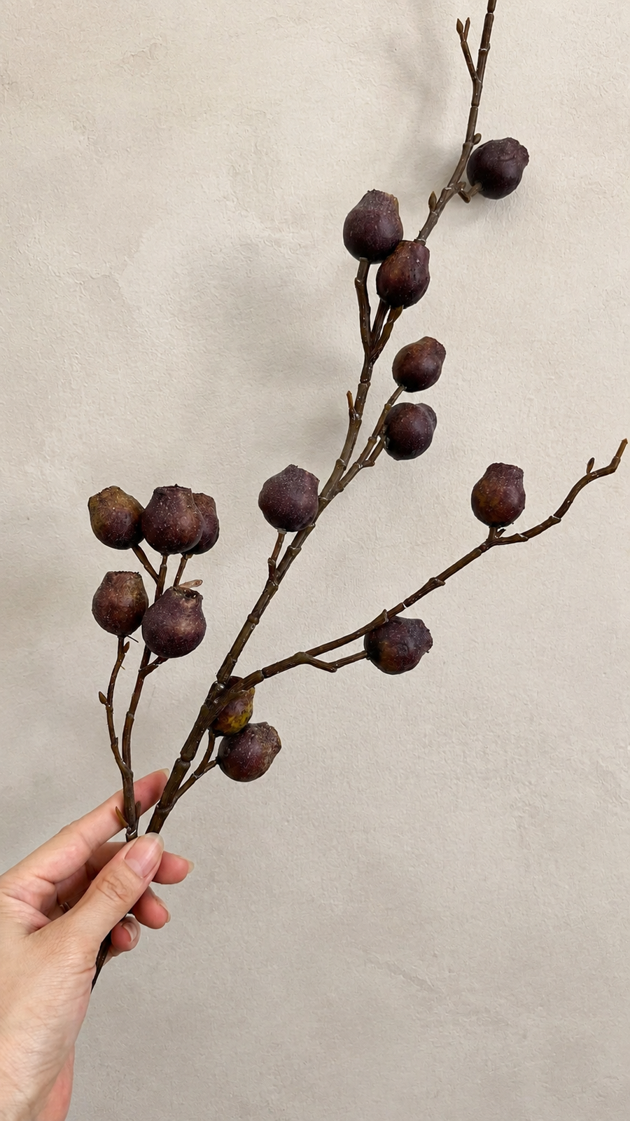 Deep Aubergine artificial berry branch close-up with textured berry clusters
