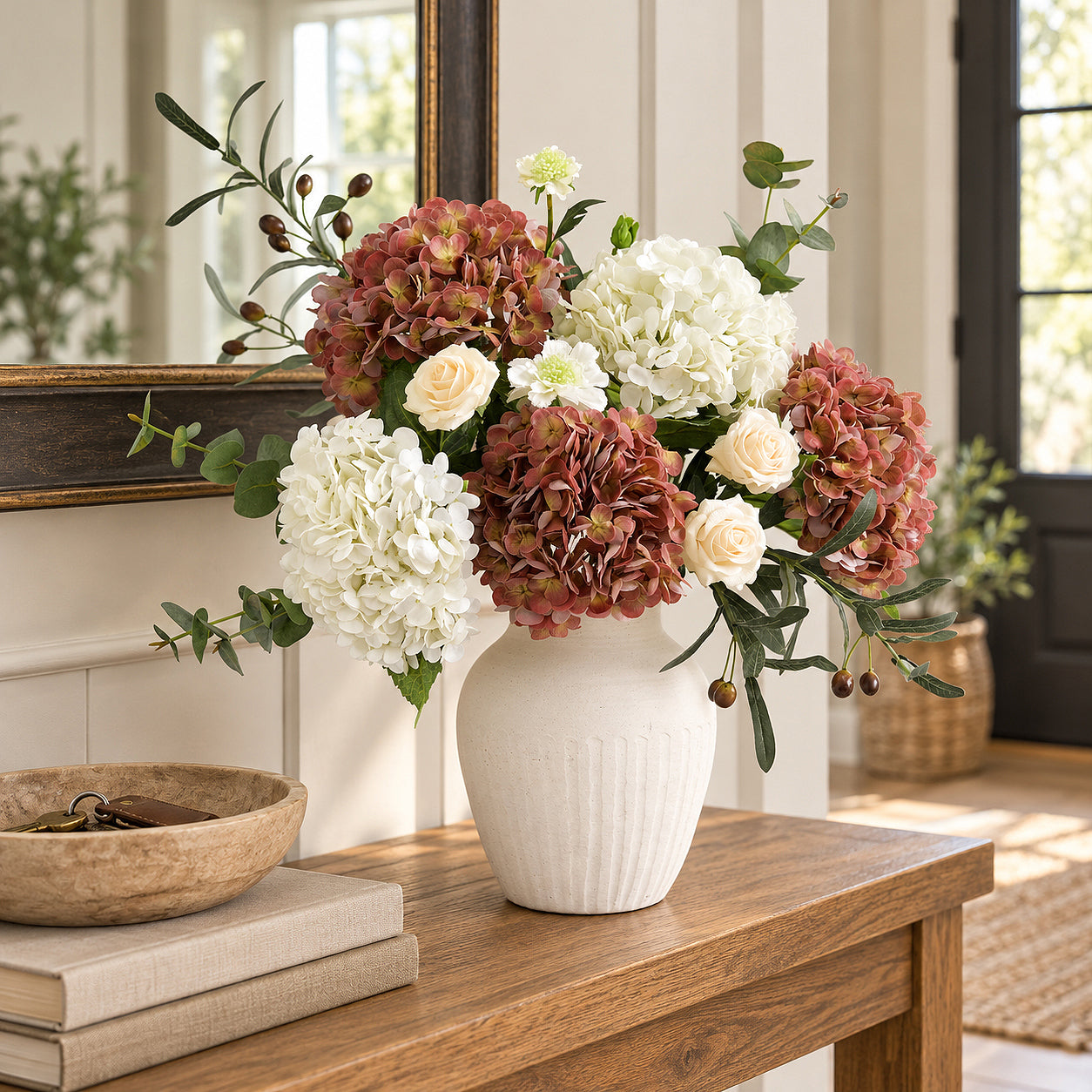 Antique brick rose hydrangeas with white flowers, pale roses and greenery in a ribbed white vase.