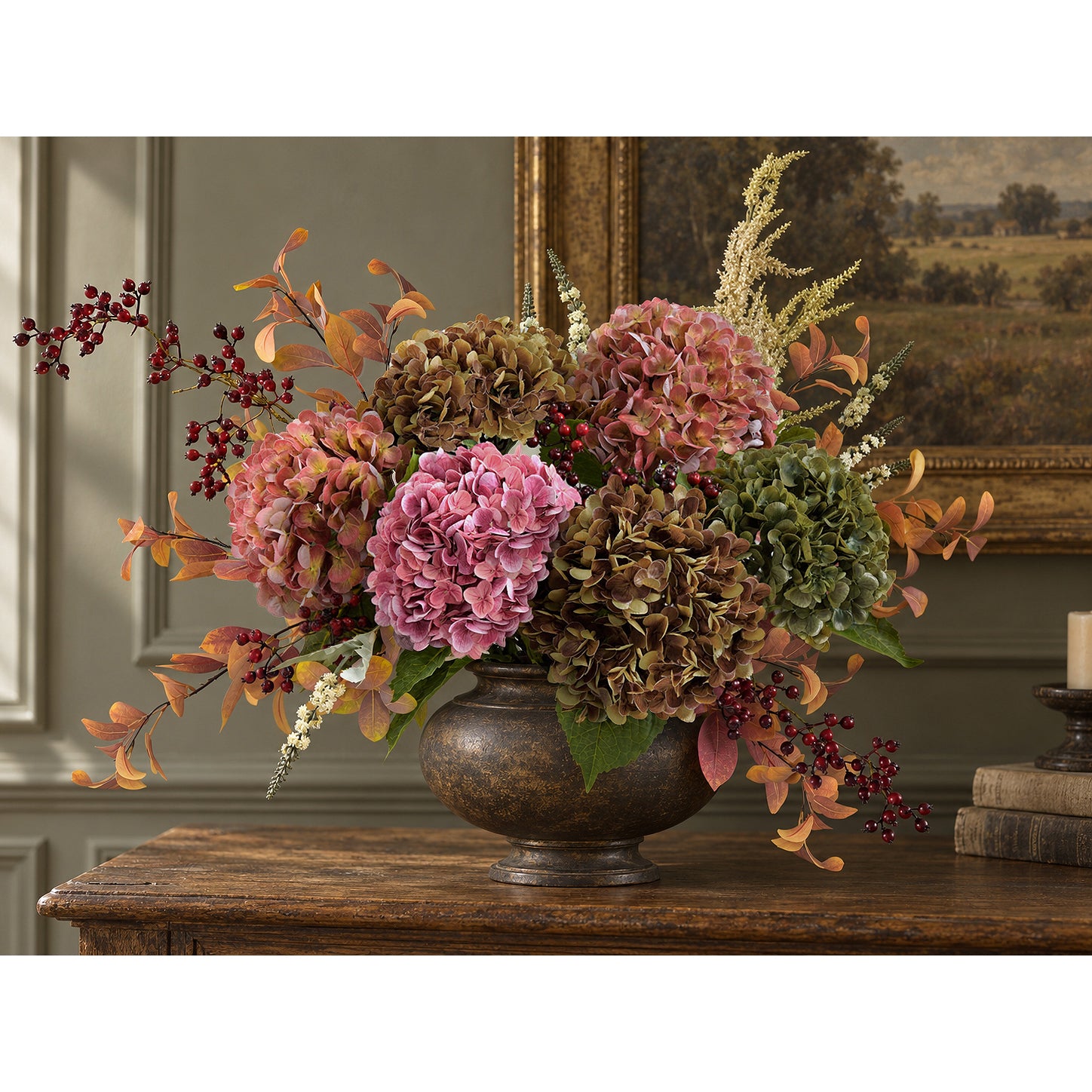 Antique russet hydrangeas with rose, purple and green blooms and autumn foliage in a bronze-toned urn.