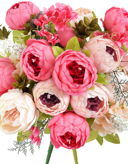 Vibrant artificial peony bouquet with shades of coral, blush pink, cream, and ivory, featuring real-touch silk petals and lush greenery.