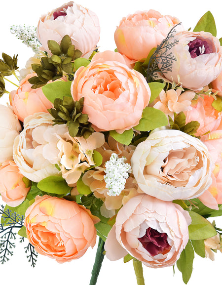 Artificial peony bouquet in soft peach, cream, and blush tones with hints of plum and green foliage. Realistic silk flowers styled for weddings, gifts, or home decor.