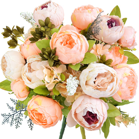 Artificial peony bouquet in soft peach, cream, and blush tones with hints of plum and green foliage. Realistic silk flowers styled for weddings, gifts, or home decor.