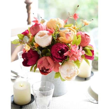 Sunset Whisper artificial floral arrangement with gold taper candle holders, styled in a cozy home setting.