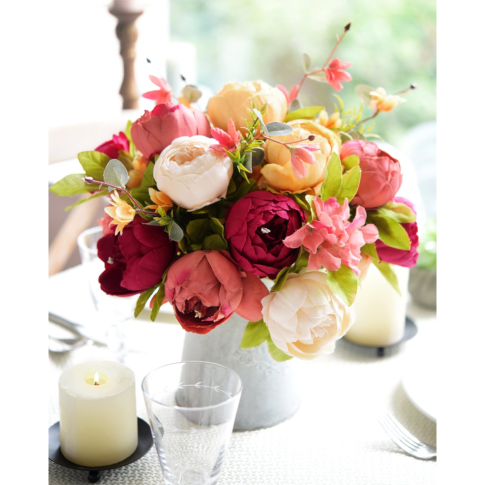 Sunset Whisper artificial floral arrangement with gold taper candle holders, styled in a cozy home setting.