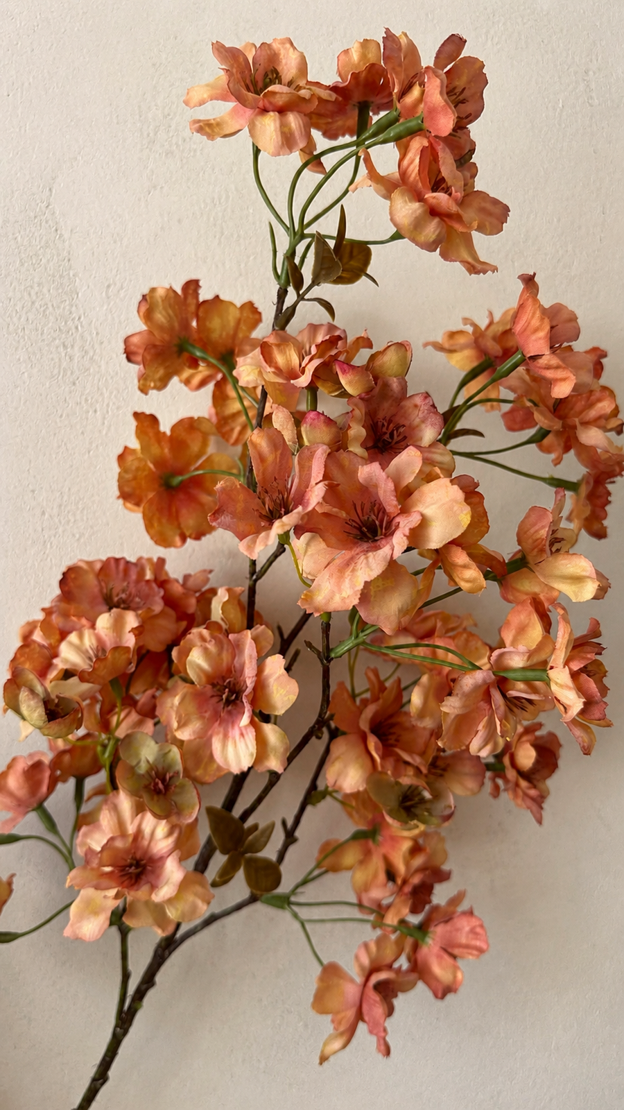 Autumn apricot artificial cherry blossom branch with warm coral and golden petals