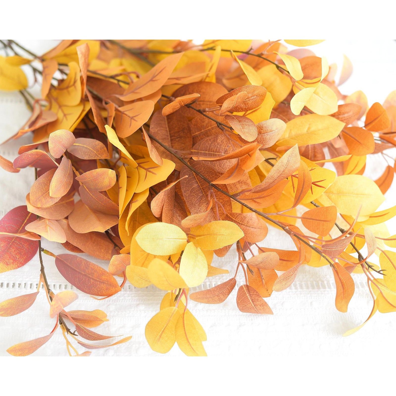Tall faux fall branches showing layered blush pink, golden yellow and burnt orange foliage.