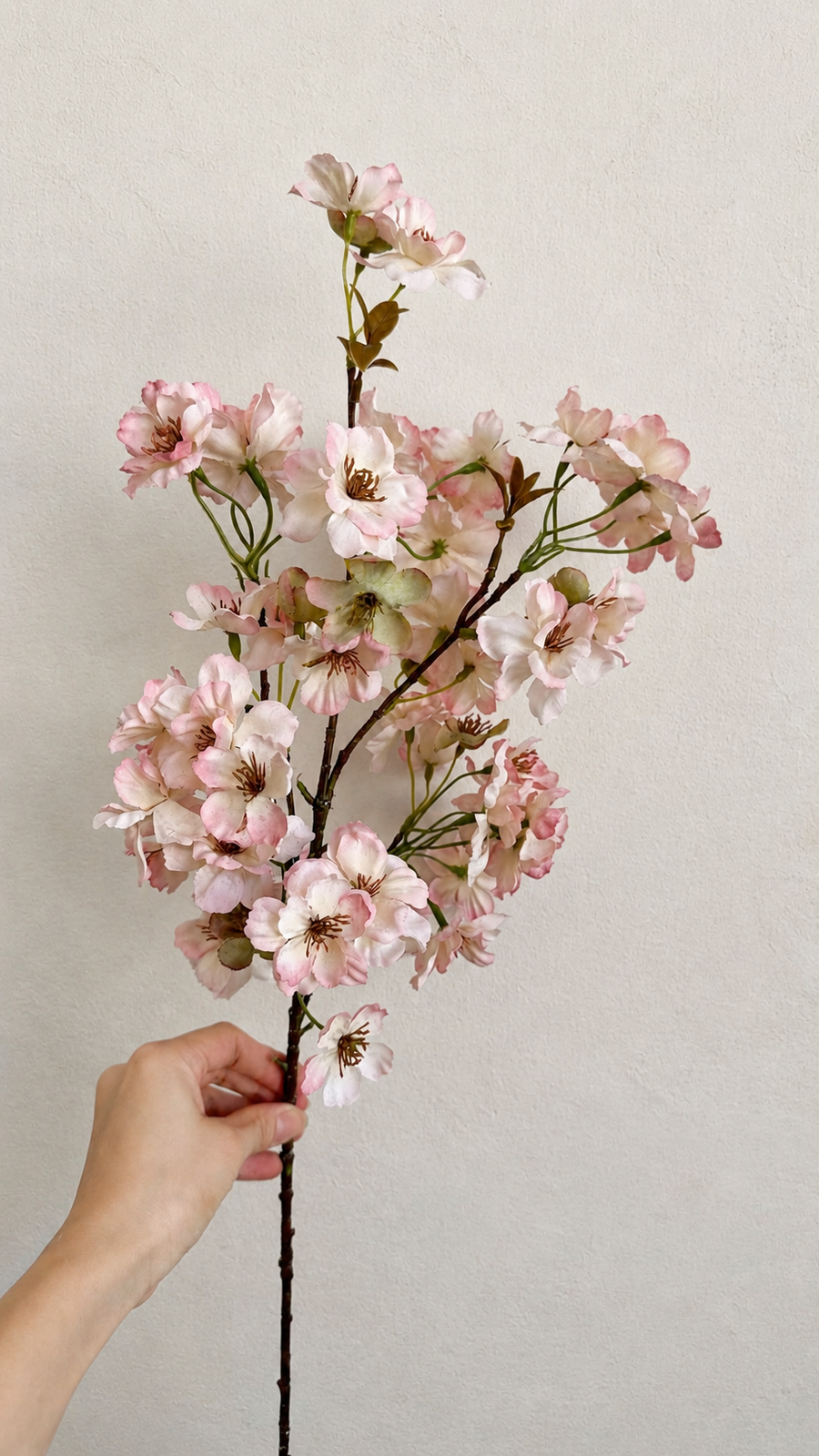 Full-length 37.4-inch blush pink artificial cherry blossom branch held for scale