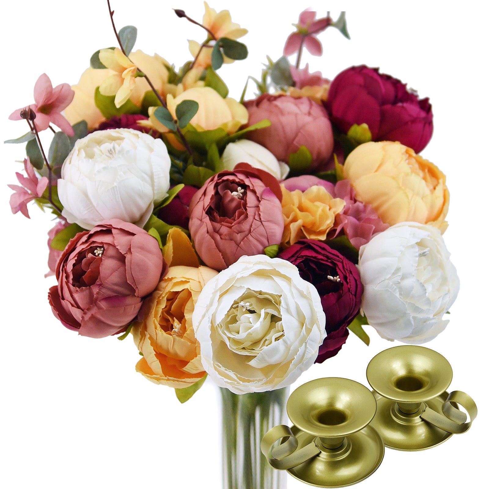 Close-up of realistic silk peonies and hydrangeas in warm hues of barley white, faded orange, and pinkish red, with candle holders.