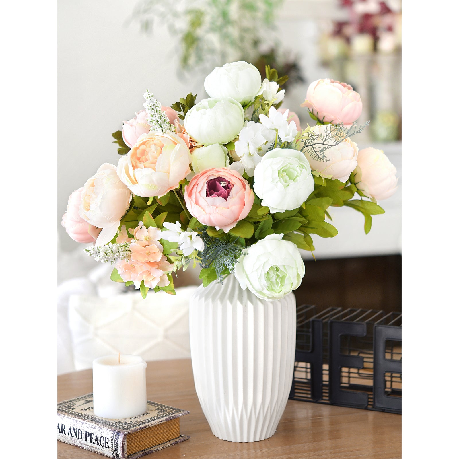 Elegant pastel peony centerpiece with soft pink and green tones, styled in a modern white ribbed vase for weddings or events.