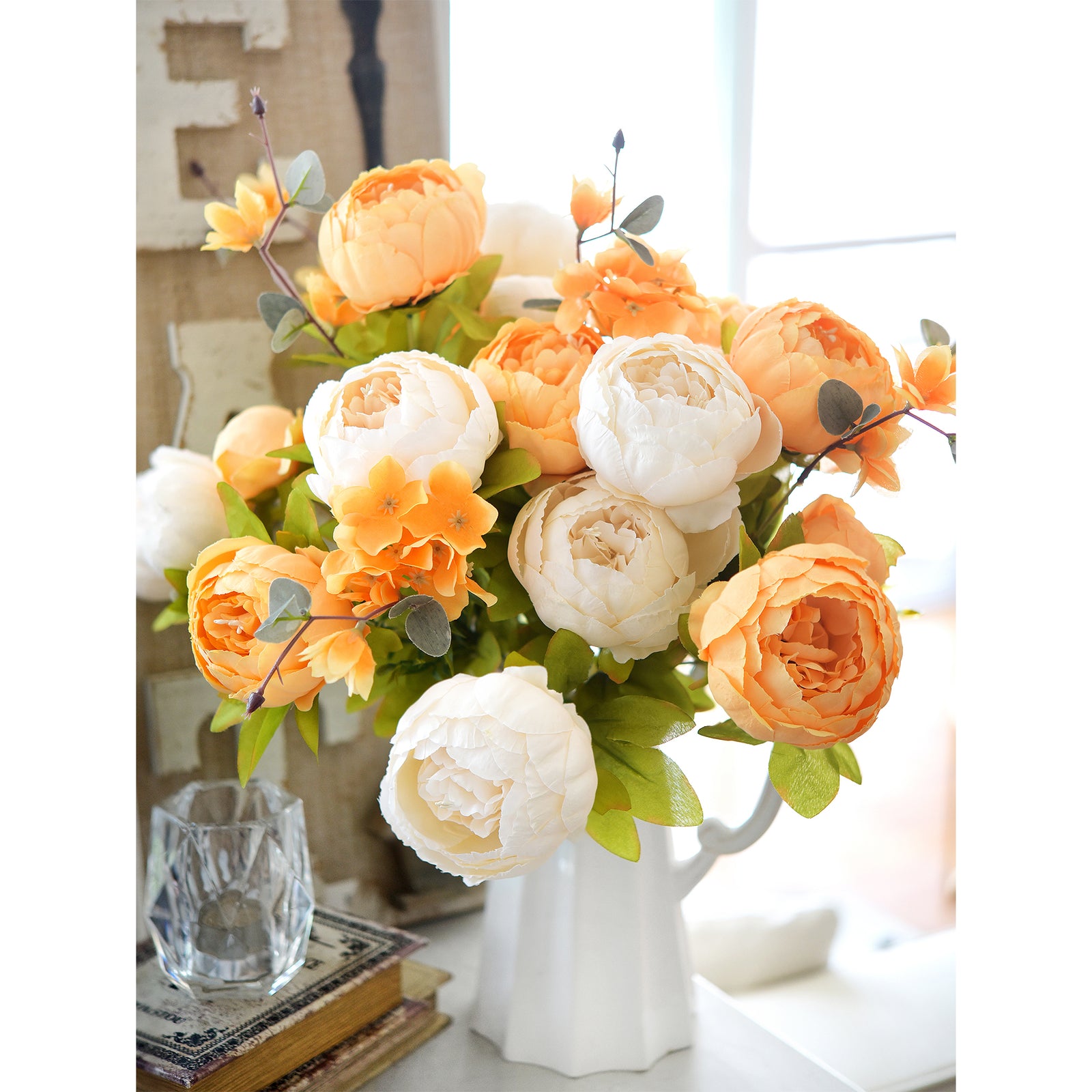 Golden-hued floral arrangement with orange and cream tones, arranged in a decorative vase for fall or autumn décor