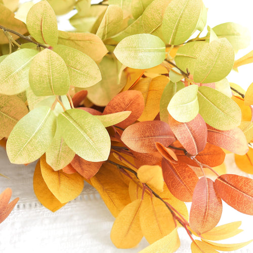 Mixed green, golden yellow and burnt orange artificial fall branches in an alternate view.