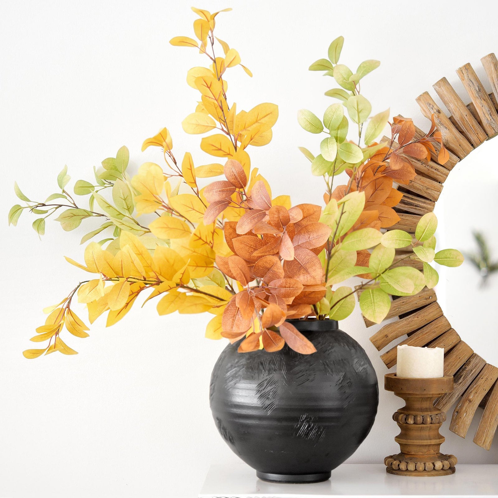Faux fall leaf branches showing the green, gold and burnt orange color mix.