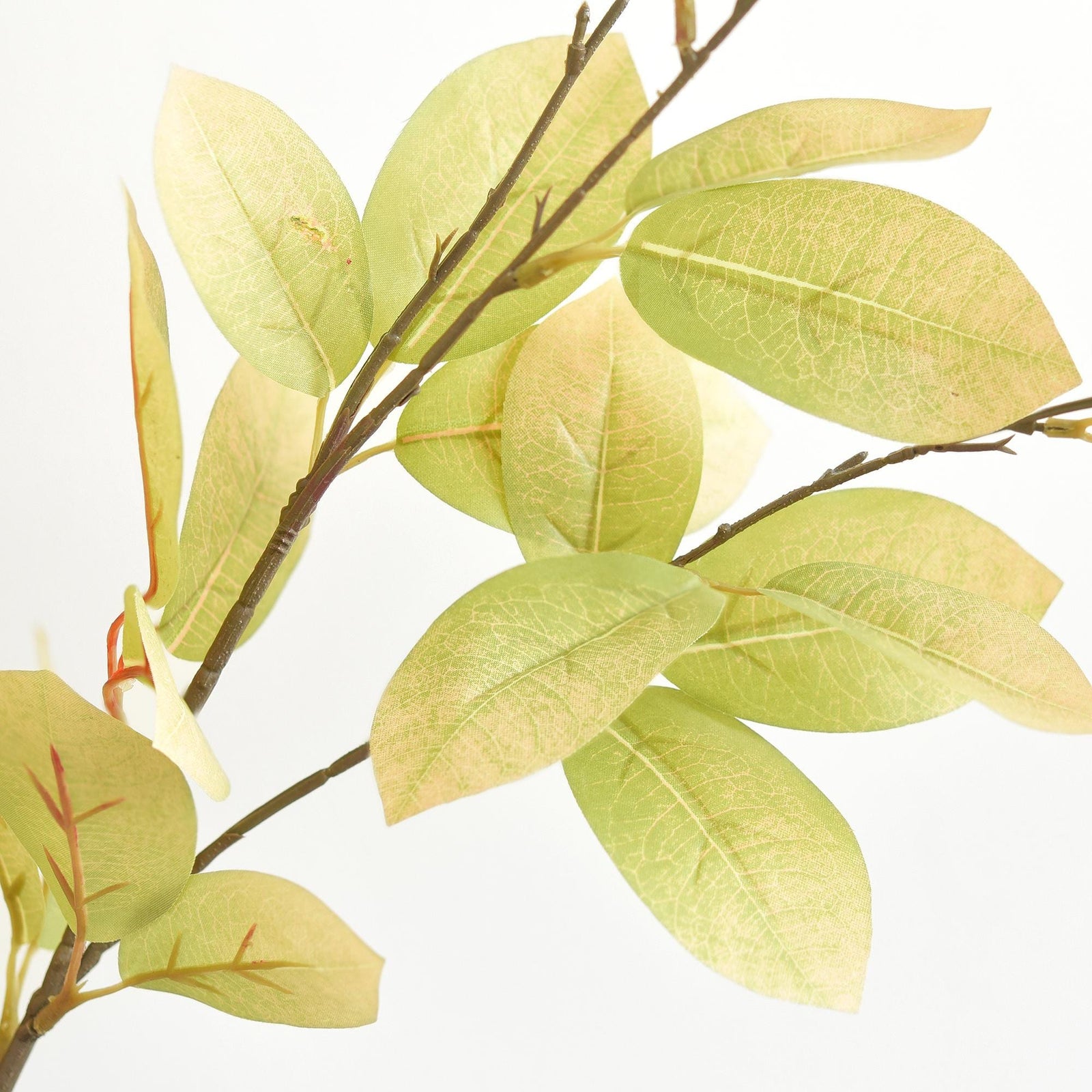Detail view of green, golden yellow and burnt orange artificial fall foliage.