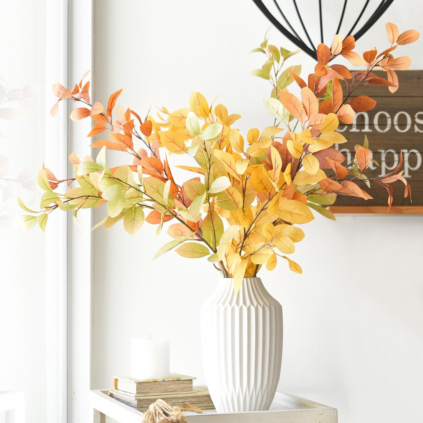 Flexible faux fall leaf branches shown in a layered green and warm autumn palette.
