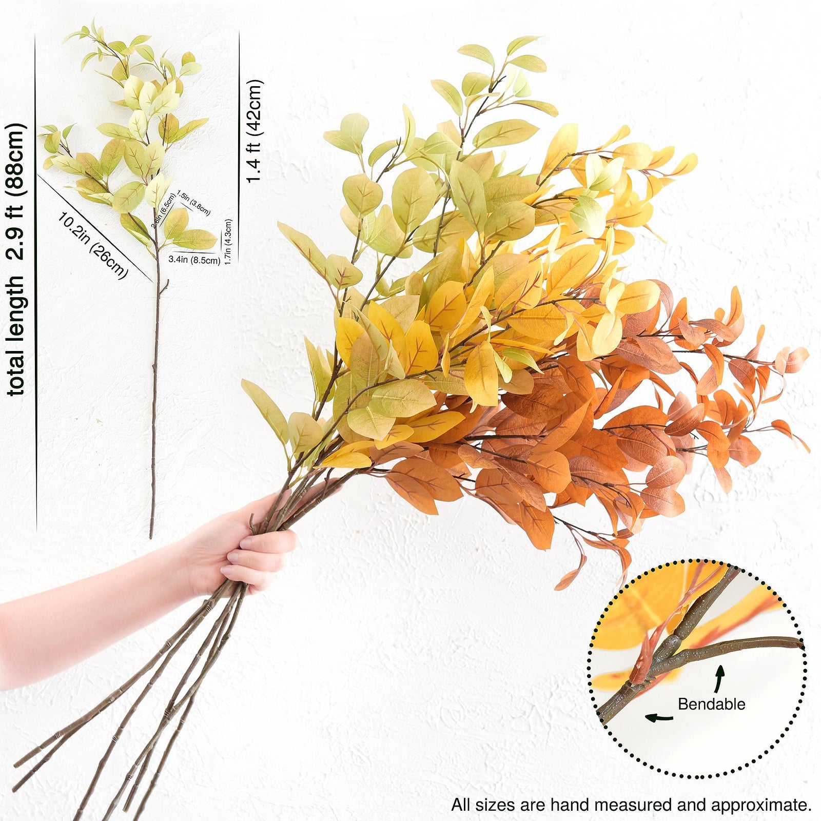 Green, gold and orange artificial leaf branches shown in an additional seasonal styling view.
