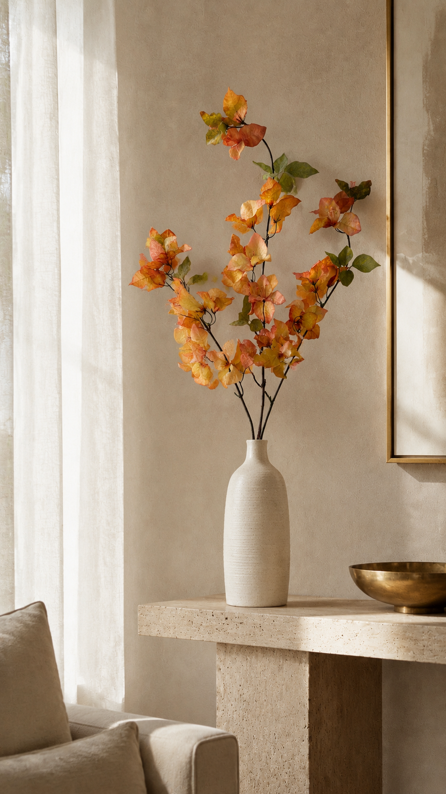 Autumn Apricot artificial bougainvillea branch styled in a tall vase in a neutral home interior