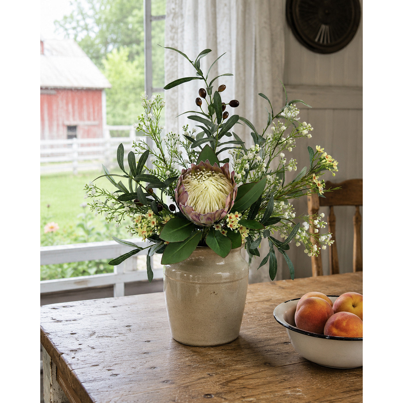 Artificial King Protea arrangement styled in a farmhouse crock.