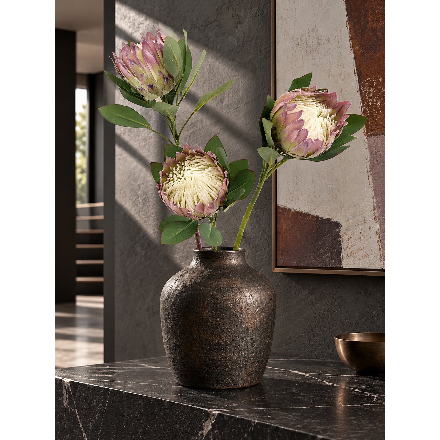 Artificial King Protea stems styled in a modern interior.