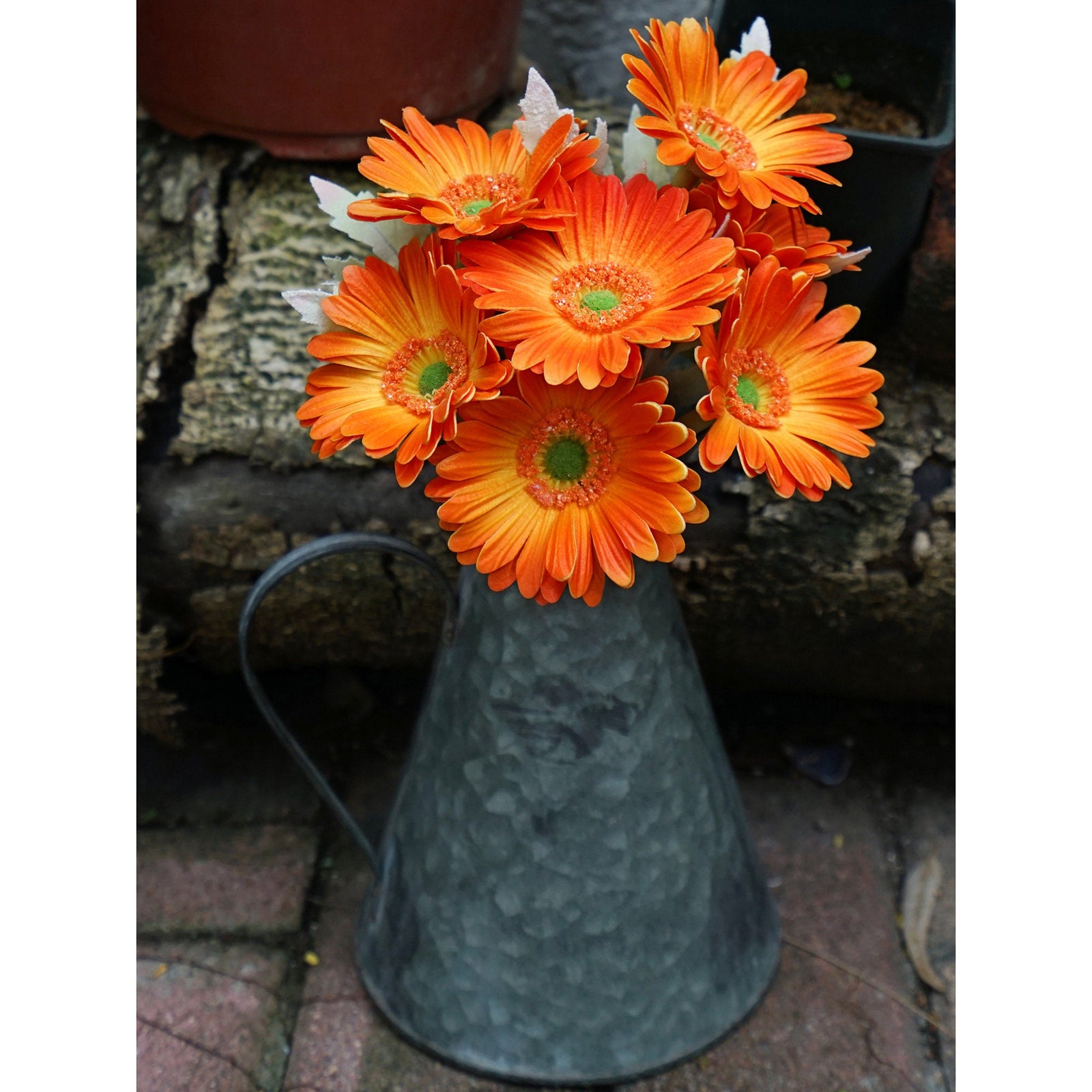 Marmalade orange artificial gerbera flowers shown in an additional close product view.