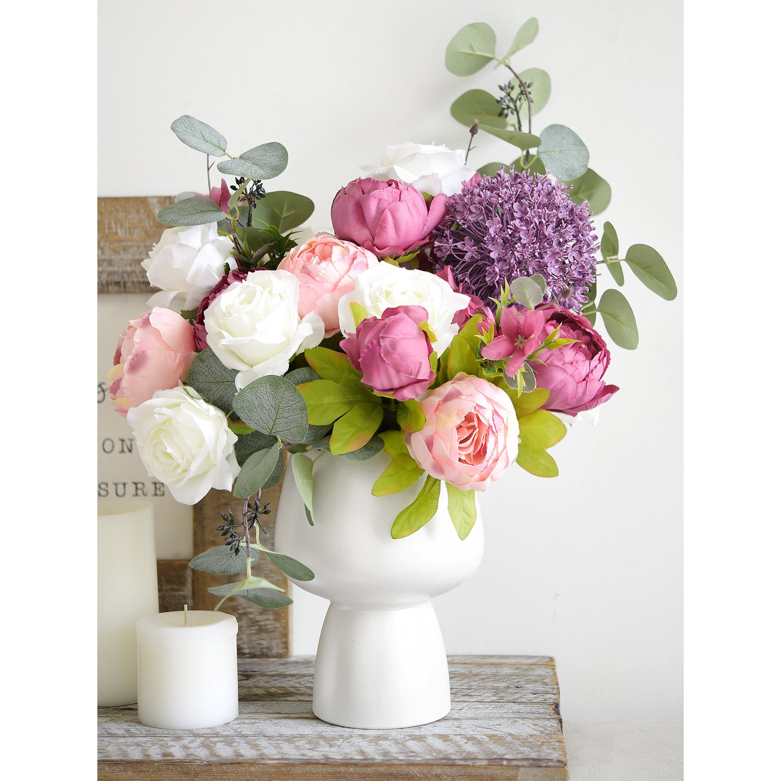  Modern centerpiece with pink, purple, and cream peonies in a matte white vase, perfect for weddings or special events.