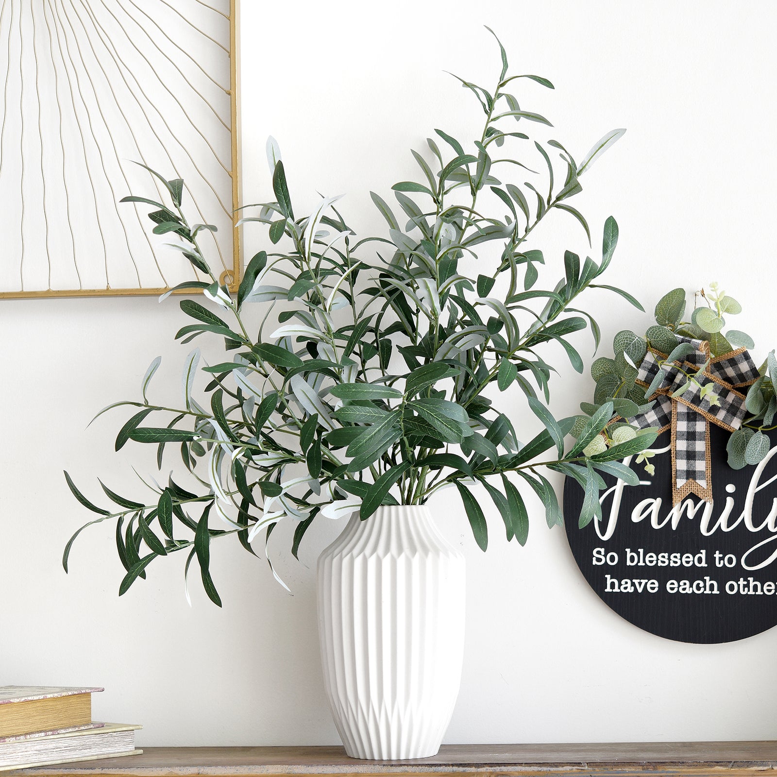 Lush artificial olive branches in a white ribbed vase, accompanied by a family sign, perfect for home or office décor