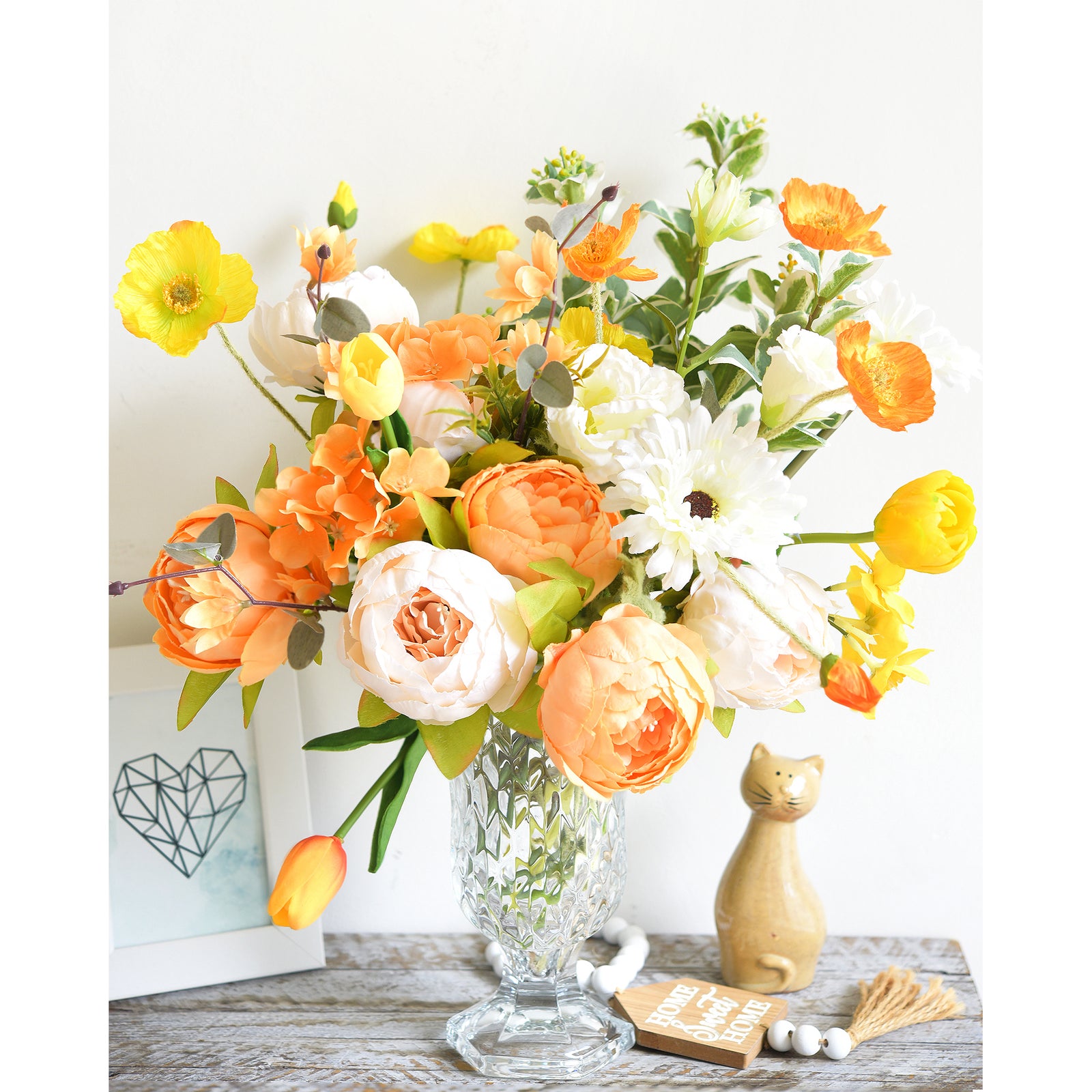 Orange and yellow floral arrangement featuring peonies, daisies, and tulips in a decorative vase, ideal for weddings or home styling.