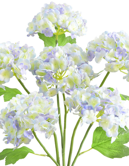 Six periwinkle and white real touch hydrangea stems with rounded blooms and green leaves on a white background.