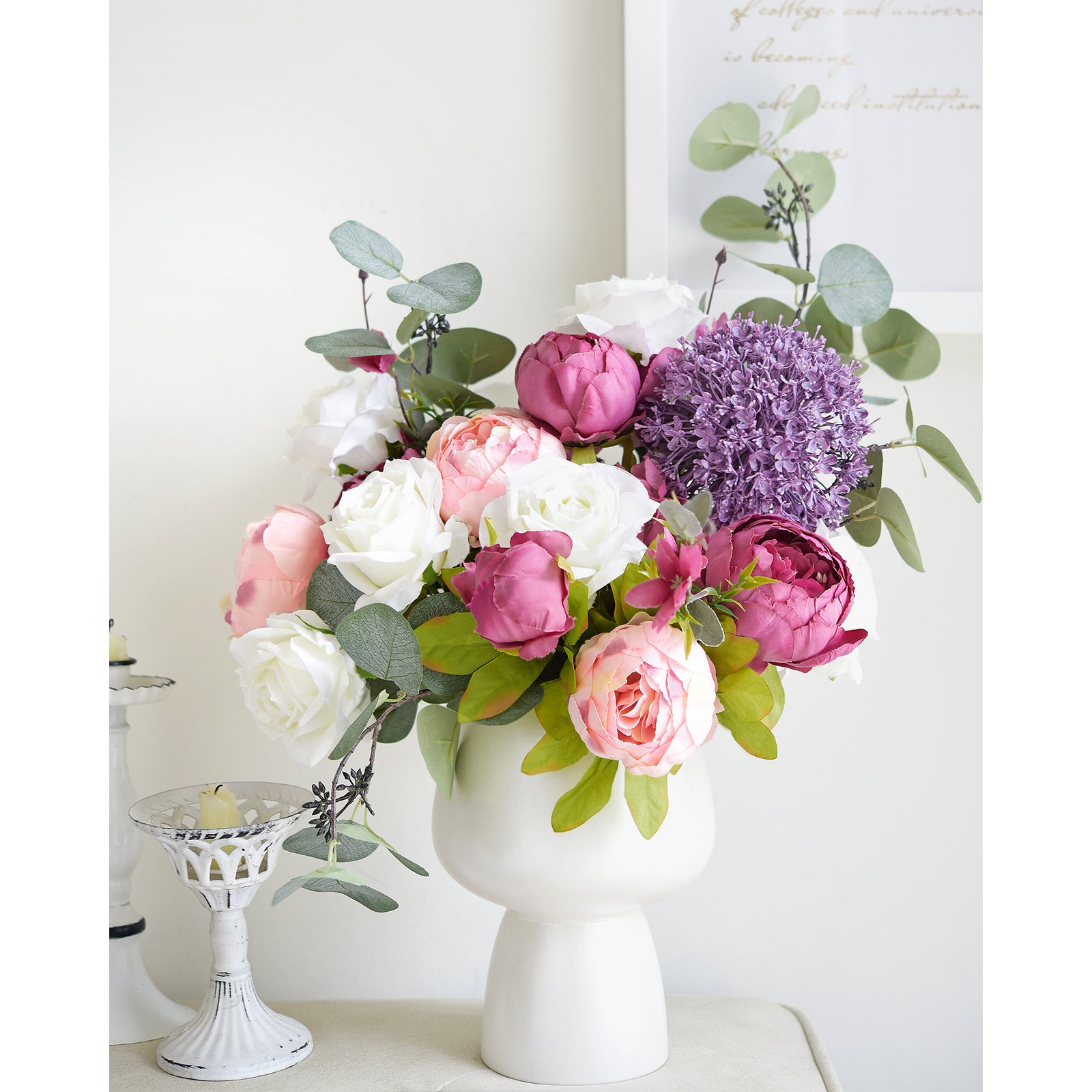 Pink and purple floral arrangement with peonies and greenery in a classic white vase, ideal for home décor.
