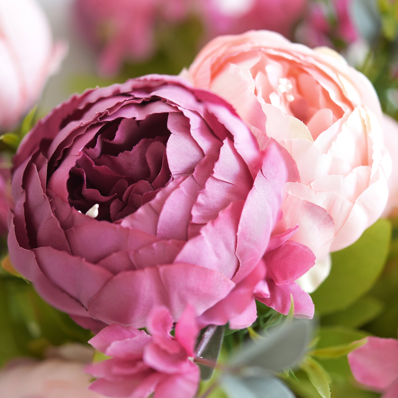 Close-up of pink and purple peony silk flower with realistic layered petals, showcasing vibrant color and texture.
