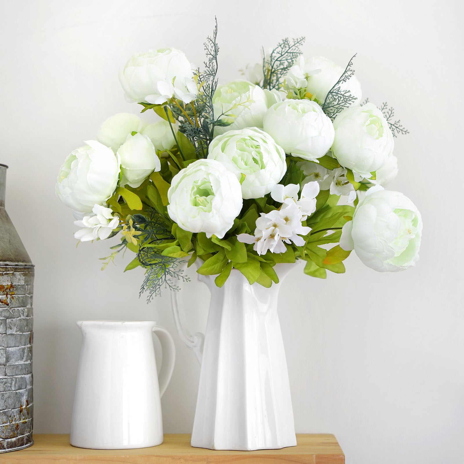 Seasonal silk floral display featuring green and white peonies arranged in a ceramic vase for modern home styling