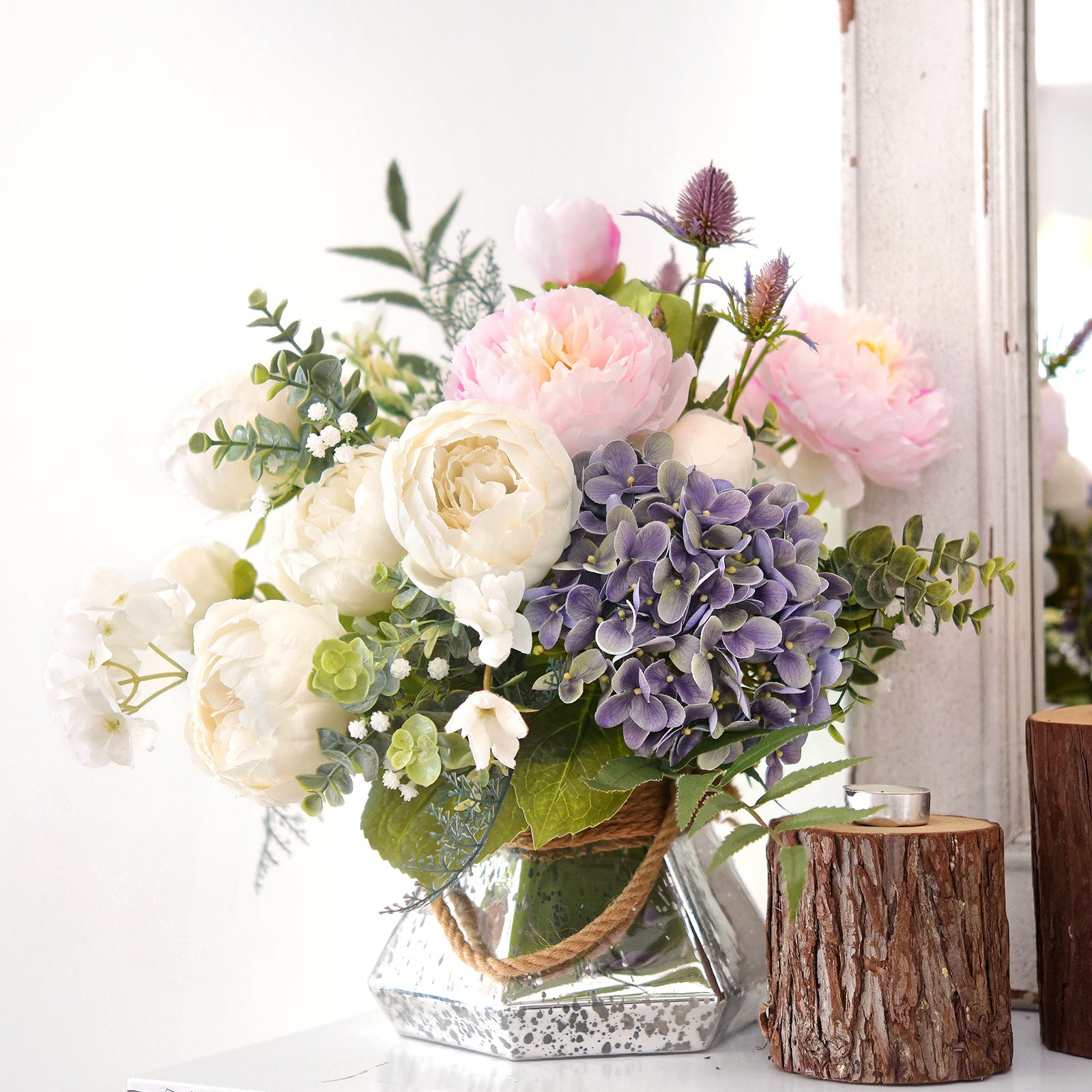 Spring-inspired artificial bouquet with white and pastel flowers arranged in a crystal vase, enhancing any space