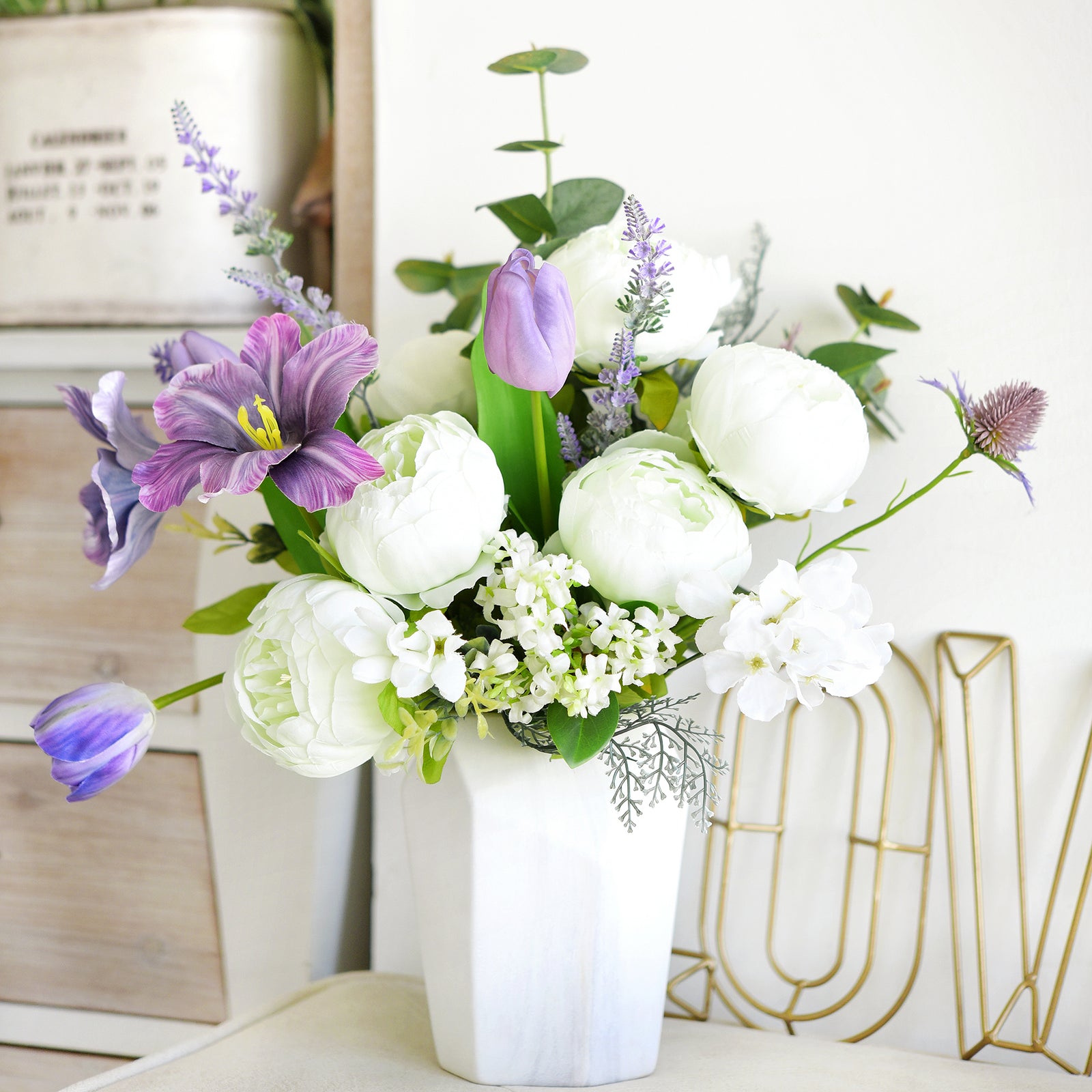 Vibrant purple and white peony bouquet in a white vase, ideal for modern home or office styling.