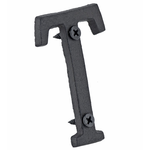 A cast iron house letter sign ‘T’ with white background 