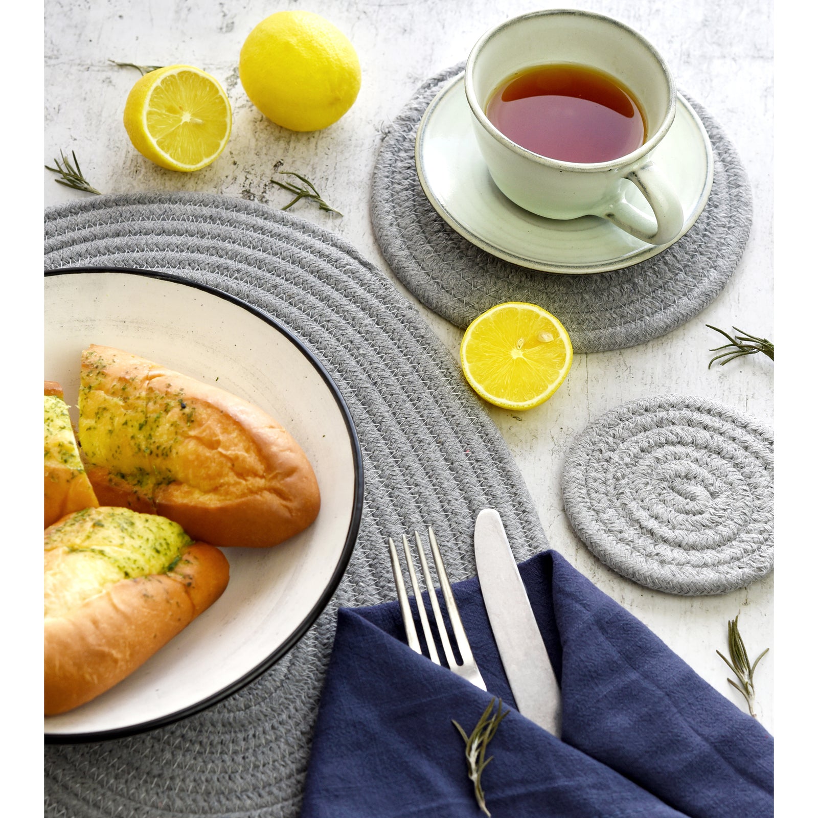 Gray cotton table mat set shown in an additional dining and decor styling view.
