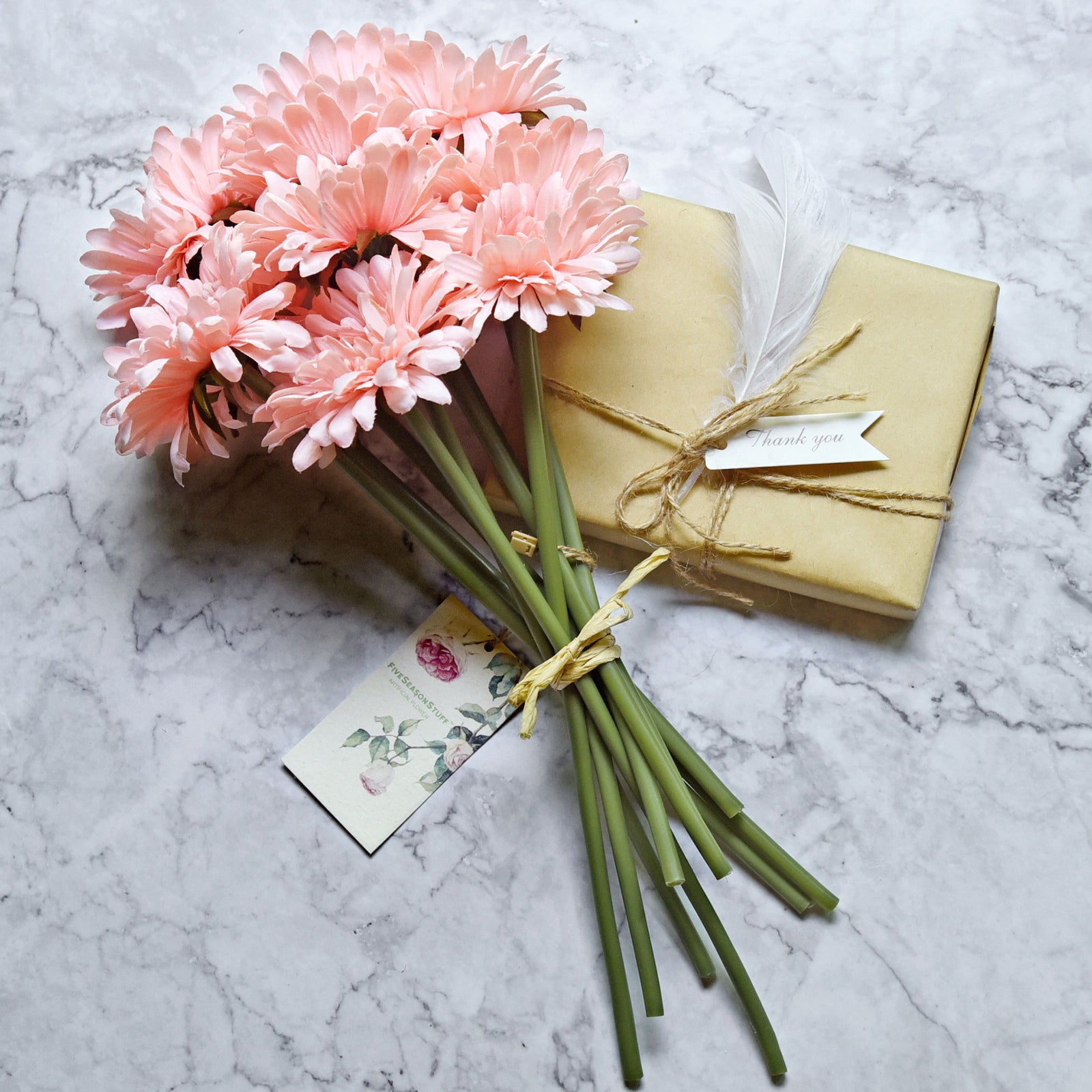 Light pink artificial gerbera flower stems shown in an additional arrangement view.