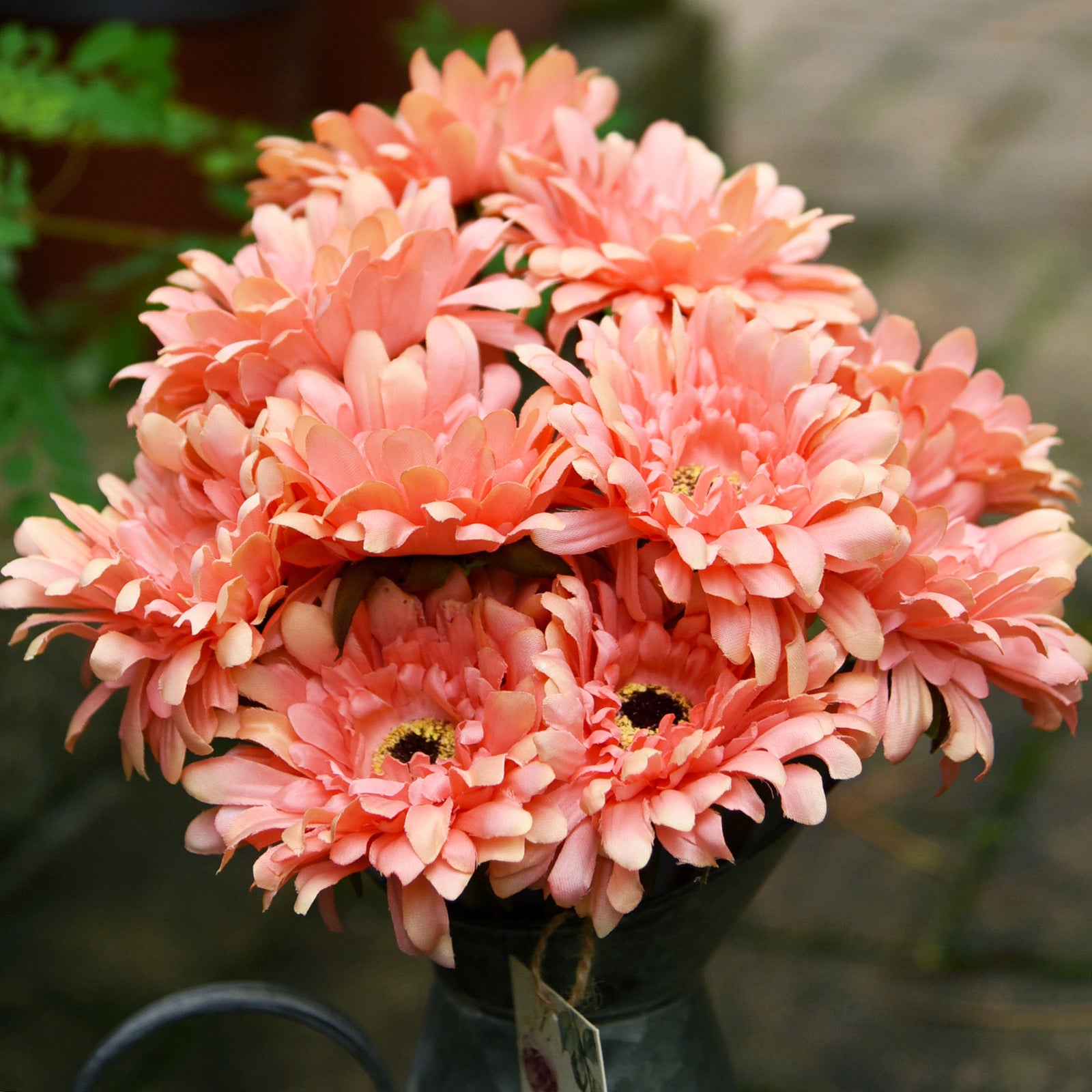 Orange pink artificial gerbera flower stems shown in an additional arrangement view.