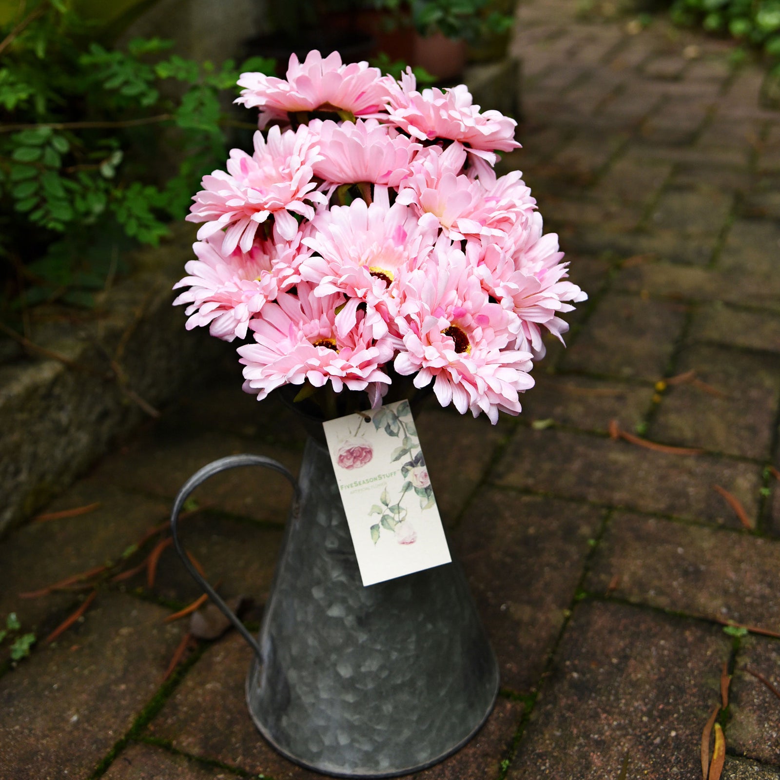 Pink artificial silk gerbera stems shown in an additional styling view.