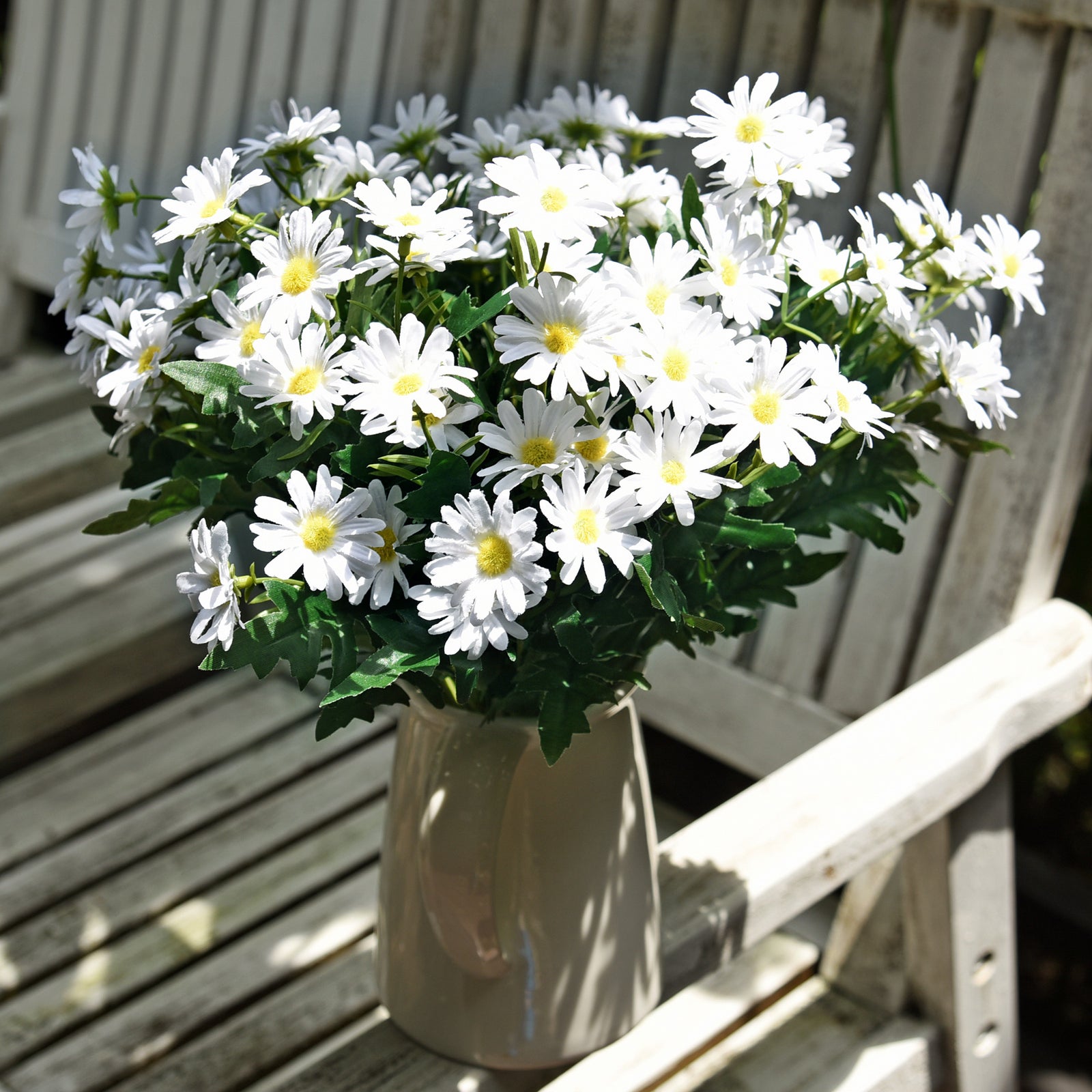 Simply White artificial daisy flowers with green leaves shown from another angle.
