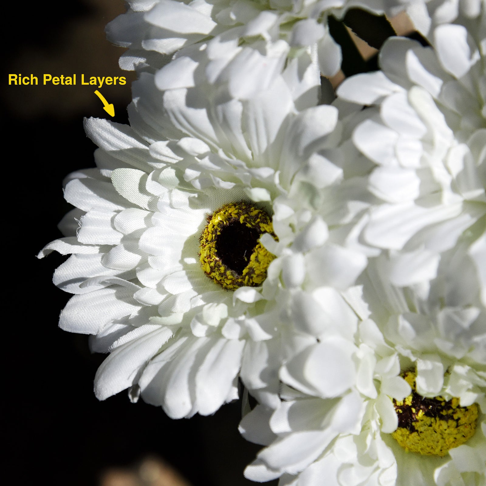 White artificial silk gerbera flowers shown with layered blooms and green stems.