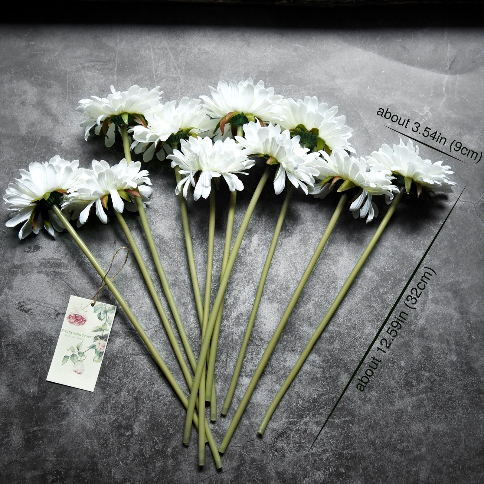 White artificial gerbera flower stems shown in an additional styling view.